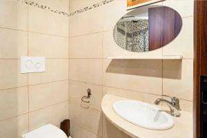 a bathroom with a sink and a mirror at Trullo Mandorlo in Martina Franca +16 photos