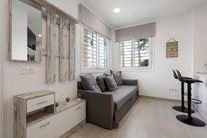 a living room with a couch and a table at Apartamentos Sealmar Moliere in Málaga