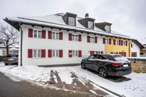 a black car parked in front of a building at Fewo Gipfelstürmer mit Königscard in Nesselwang