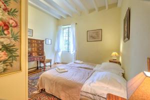 a bedroom with a bed and a window at Le Bel Prat in Domme +27 photos