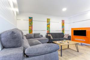 a living room with two couches and a tv at Las Palmeras in Güimar