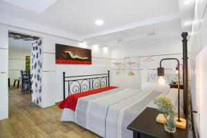 a bedroom with a bed and a desk and a table at Las Palmeras in Güimar