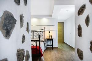 a bedroom with a bed with rocks on the wall at Las Palmeras in Güimar