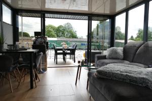 a living room with a couch and a table at Führerscheinfreies mobiles Hausboot in Rechlin +21 photos