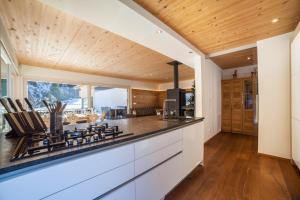 a kitchen with white cabinets and a counter top at Chalet de Ultimis in Ultimo