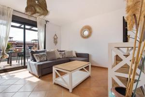 a living room with a couch and a table at Sunny Home in Lajares