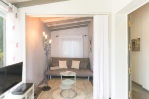 a small living room with a couch and a table at Sobreirinho - Selão da Eira in São Teotónio