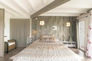 a bedroom with a large bed in a room at Sobreirinho - Selão da Eira in São Teotónio +28 photos