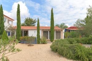 a house with cypress trees in a garden at Sobreirinho - Selão da Eira in São Teotónio