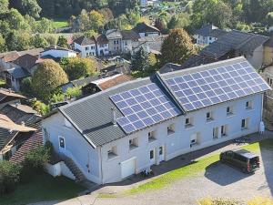 an image of a house with solar panels on it at Logis Les Forges in Arvillard