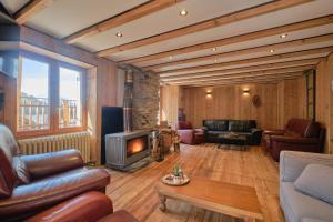 a living room with leather furniture and a fireplace at L'auberge du Bati in Besse