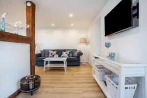 a living room with a couch and a tv at Ferienwohnung Manthei in Kluis