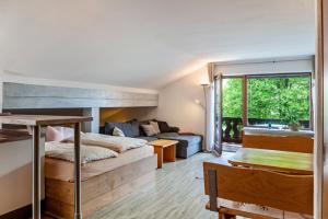 a bedroom with a bunk bed and a couch at Johannas Alm in Garmisch-Partenkirchen