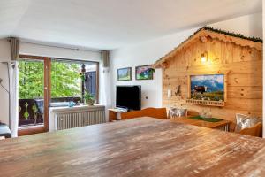 a living room with a large wooden table at Johannas Alm in Garmisch-Partenkirchen