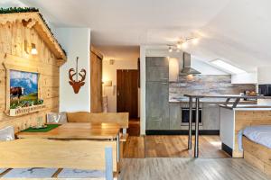 a kitchen and living room with a table in a room at Johannas Alm in Garmisch-Partenkirchen