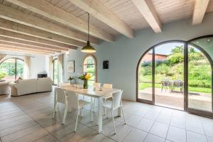 a living room with a white table and chairs at Chalet Azzurro in Trequanda