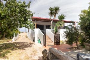a house on the beach with trees in front of it at A Look Salento in Castrignano del Capo