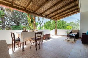 an outdoor dining room with a table and chairs at A Look Salento in Castrignano del Capo