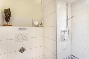 a bathroom with a shower with a glass door at Ferienwohnung Richter in Kirchhundem +25 photos