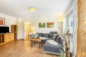 a living room with a couch and a table at Ferienwohnung Richter in Kirchhundem