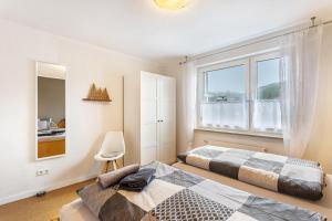 a bedroom with two beds and a window at Ferienwohnung Richter in Kirchhundem