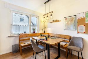 a dining room with a wooden table and chairs at Ferienwohnung Richter in Kirchhundem