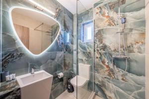 a bathroom with a sink and a mirror at Roys Blu in Kavos