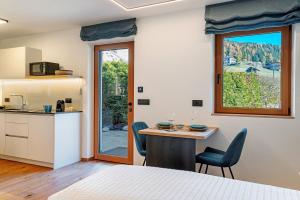 a room with a kitchen and a table with chairs at Apt Lara Ruveda 2 in Ortisei