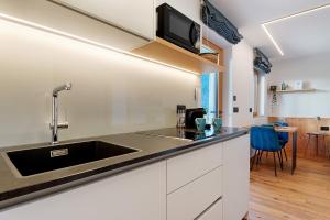 a kitchen with a sink and a counter top at Apt Lara Ruveda 2 in Ortisei +21 photos
