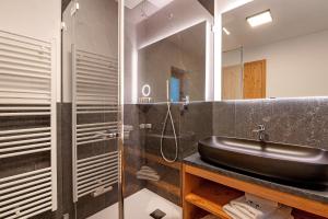 a bathroom with a sink and a shower at Apt Lara Ruveda 2 in Ortisei