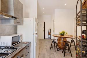 a kitchen with a white refrigerator and a table at G House Dolceacqua in Dolceacqua +28 photos