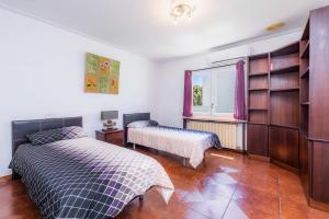 a bedroom with two beds and a window at Villa Paca in Cala Ratjada +17 photos