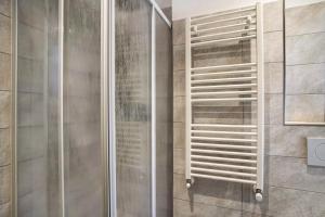 a shower with a glass door in a bathroom at G House Dolceacqua in Dolceacqua