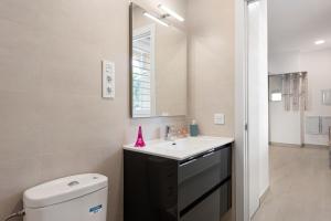 a bathroom with a sink and a mirror at Apartamentos Sealmar Moliere in Málaga +25 photos