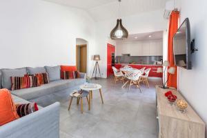 a living room with a couch and a table at Villa Petala in Albufeira