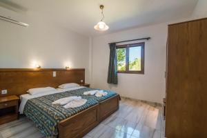 a bedroom with a bed with two towels on it at Mirage Arillas Apartment C in Arillas