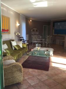 a living room with a couch and a table at Villa Corneghe with pool in Gargnano
