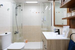 a bathroom with a shower and a toilet and a sink at Legado Marino in Santa Pola +17 photos