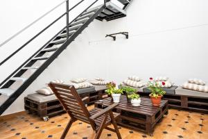 a room with a table and chairs and a staircase at Casa Calle Ancha in Barbate +11 photos