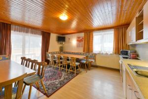 a kitchen and dining room with a table and chairs at Chalet Klösterle in Wilden