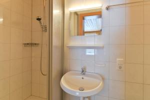 a white bathroom with a sink and a shower at Chalet Klösterle in Wilden +13 photos