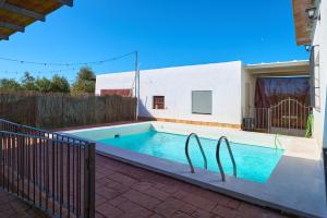 a swimming pool in the backyard of a house at Casa Rural Olivar de la Marquesa in La Carlota