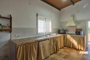 a kitchen with a sink and a counter top at Casa Rural Olivar de la Marquesa in La Carlota