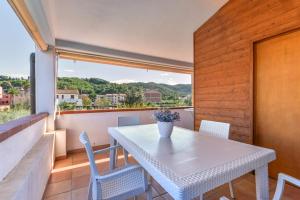 a white table and chairs on a balcony at Appartamenti Marisol in Campo nell'Elba