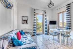 a living room with a couch and a table at Appartamenti Marisol in Campo nell'Elba