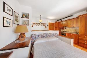 a bedroom with a bed and a table with a lamp at Monolocale Monti Pallidi in Domegge di Cadore