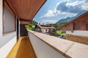 an outdoor balcony with a view of a house at Monolocale Monti Pallidi in Domegge di Cadore +16 photos