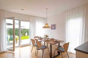 a dining room with a table and some chairs at Ferienhaus Moos in Wasserburg