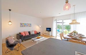 a living room with a couch and a table at Ferienhaus Moos in Wasserburg