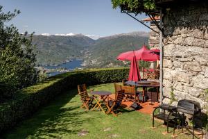 a table and chairs with an umbrella on a patio at Casa do Gerês in Geres